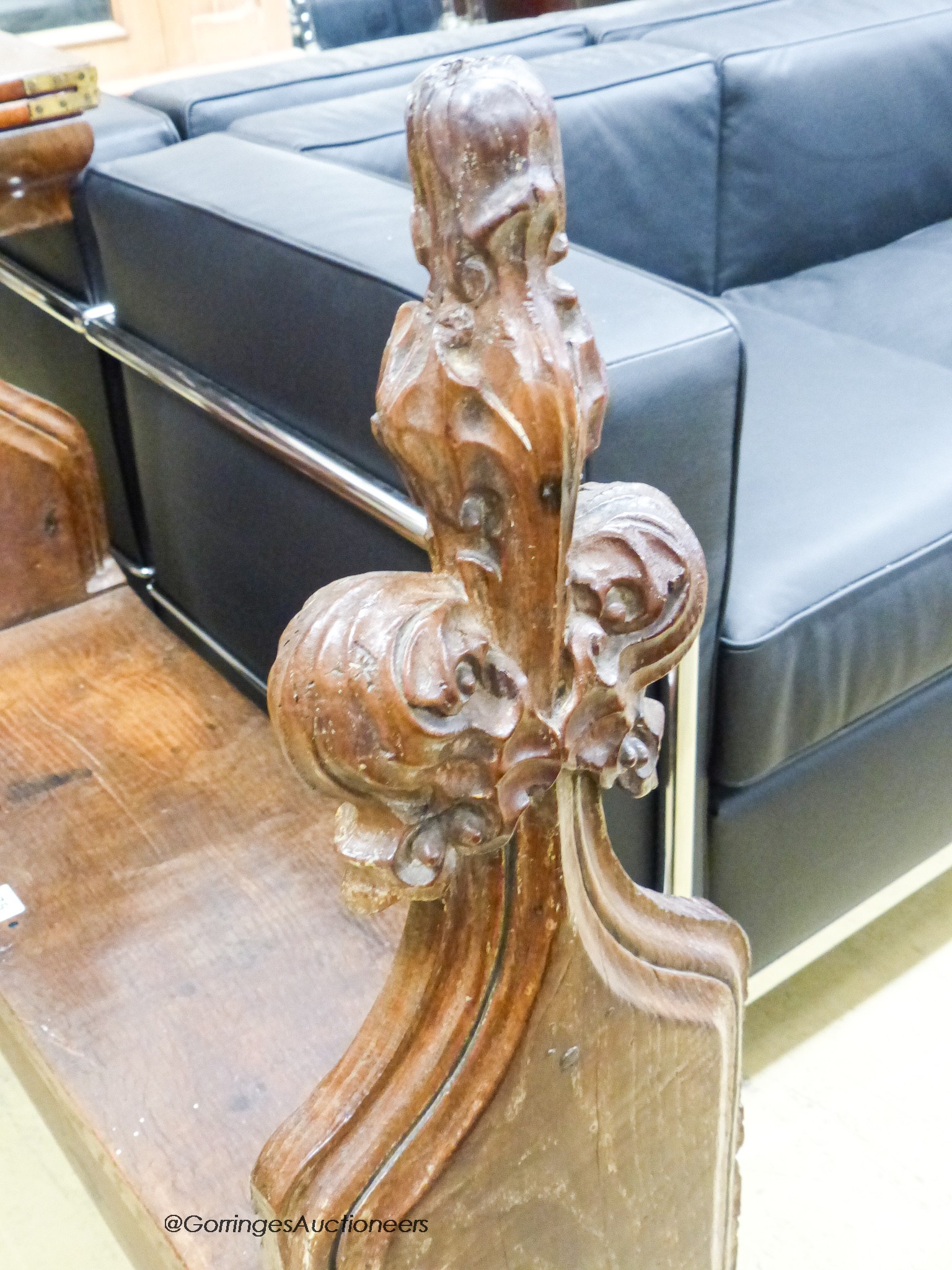 A pair of 15th century oak pew ends with stylised leaf and berry fleur-de-lys finials, joined by a later bench seat, length 85cm, depth 27cm, height 92cm